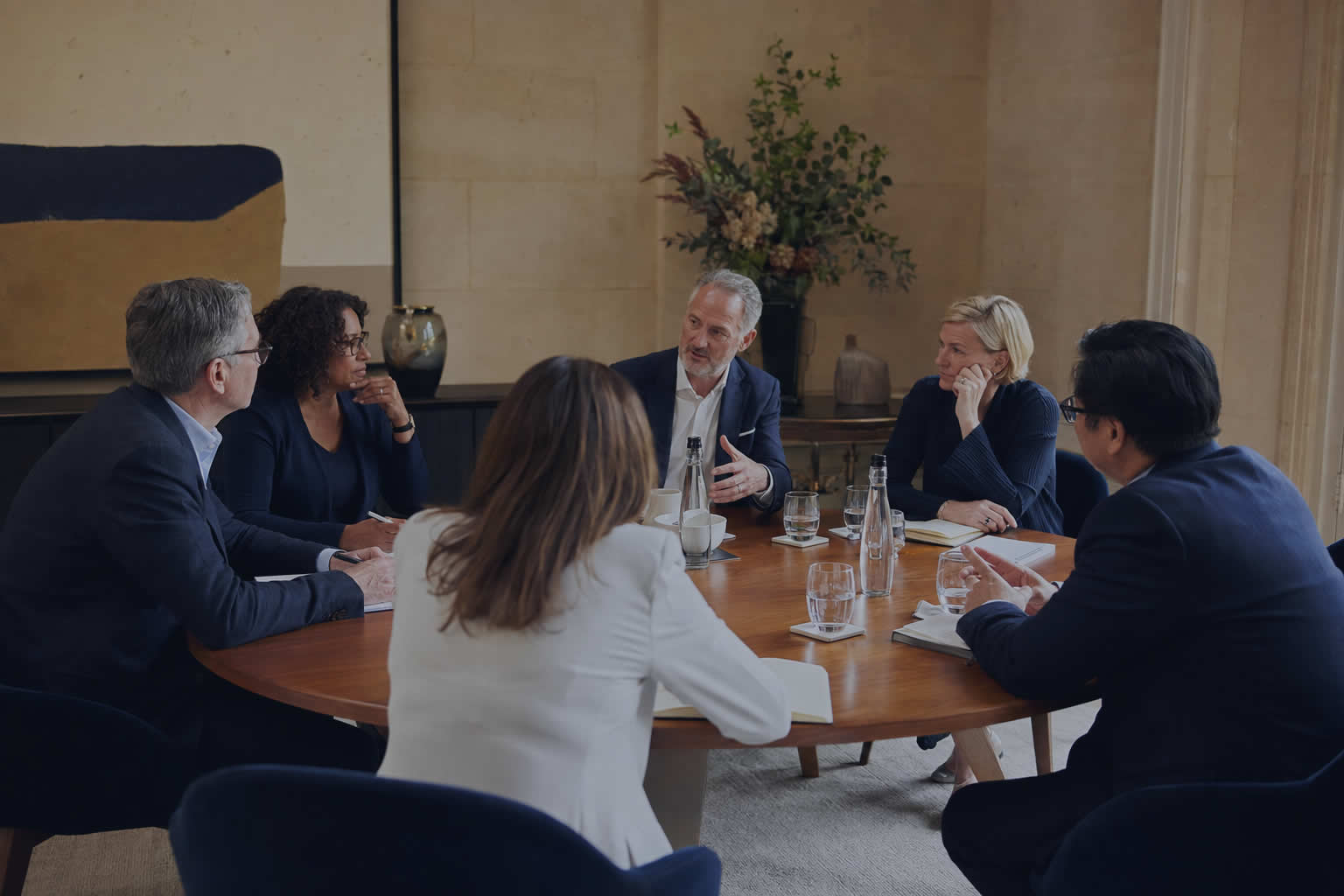 Senior executives in conversation at a private executive roundtable
